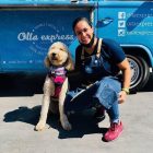 andrea ley with a dog in front her coffee truck